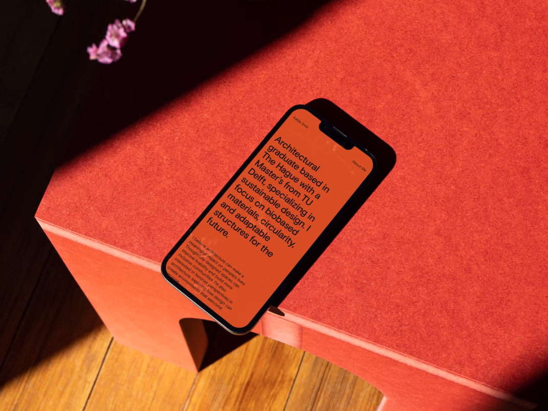 Smartphone on a red table displaying the website of Aaltje Smit.