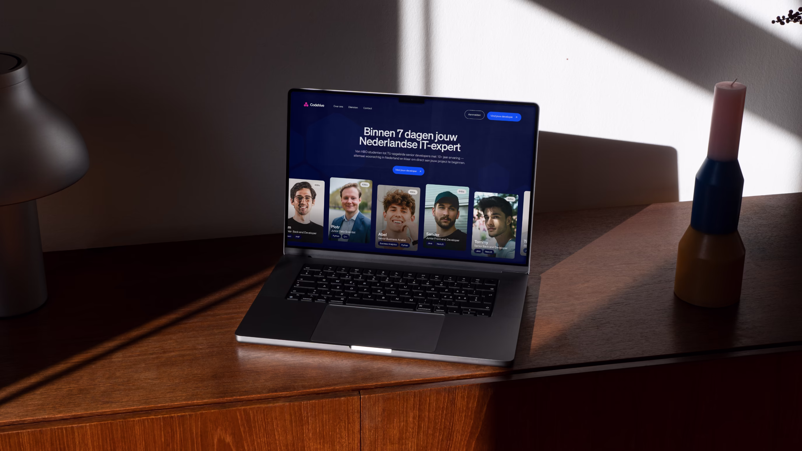 Open laptop on wooden surface displaying the website of Codehive.